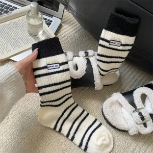 Cozy thick black and white striped knit socks for women, featuring a cute embroidered detail.