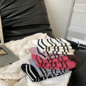 Thickened striped knit socks for women, cozy winter long socks with embroidery details.