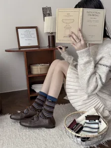 Autumn winter vintage striped cotton mid tube socks with retro cloth label for women daily wear.