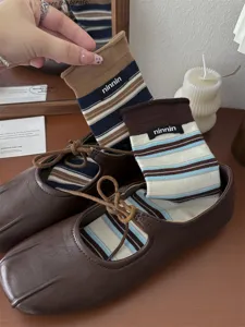 Retro striped cotton mid-tube socks detail view showing classic autumn winter design texture.