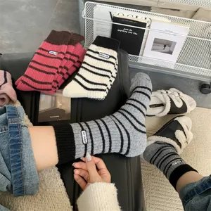 Thickened wool-blend striped mid-calf socks with cute embroidery patch for cozy winter wear.