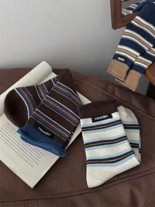 Retro striped cotton mid-calf socks with cuffed design and brand label for women.