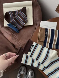 Vintage striped cotton mid-tube socks with cloth label and rolled hem for autumn style.