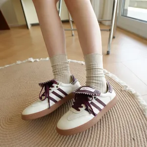 Close-up detail view of stylish beige ribbed knit mid-calf crew socks worn indoors.
