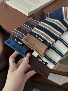Retro striped roll edge cotton mid socks detail view with brand label and soft fabric texture.