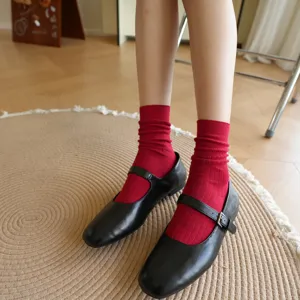 Cozy red ribbed cotton mid-calf socks showcased with black shoes, perfect daily detail.