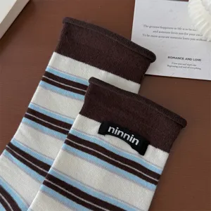 Women retro striped rolled-edge cotton mid-tube socks detail view, soft and cozy fabric.
