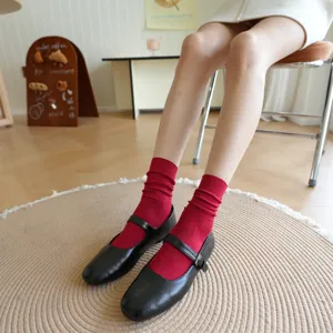 Detail view of Japanese style mid-calf stacked cotton socks in trendy Maillard red color.