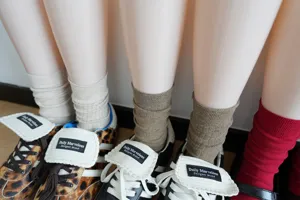 Close-up of women's ribbed and plain mid-tube cotton socks in stylish Maillard tones.
