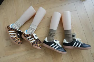 Detail shot of mid-calf ribbed cotton socks paired with stylish leopard and black sneakers.