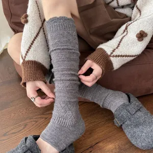 Detail shot of grey knitted wool stirrup leg warmers with cozy ribbed texture for winter warmth
