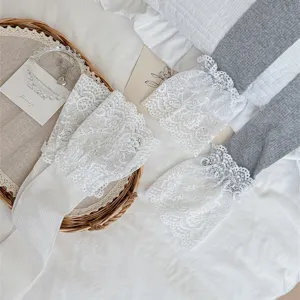 Detail shot of women's sweet lace ruffle long socks, breathable thin fabric, cute style.