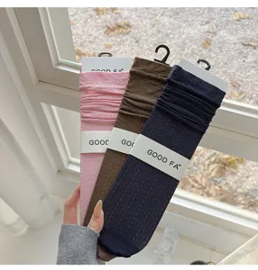 Close-up detail of spring summer women wave pattern hollow high elastic calf socks display.