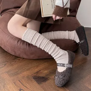 Cozy knitted wool leg warmers for women, warm ribbed long socks with vintage style design.