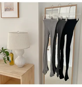 Detail shot of wide ribbed stirrup leggings in solid cotton colors, comfortable everyday wear.
