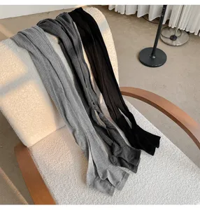 Ribbed tights detail shot, cozy chair display, soft cotton texture, simple everyday wear.