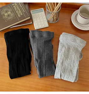 Detailed view of ribbed stirrup tights in solid colors, soft cotton fabric and neat texture.