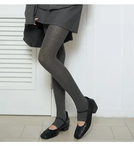 Detail shot of women grey ribbed stirrup leggings, showing texture and matched shoes.