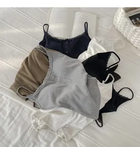 Ribbed lace camisole with chest pad and buttons, stylish layered flat lay detail view.