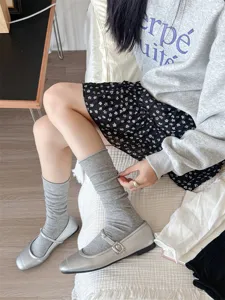 Grey women stack socks, casual knee high leg warmers, soft knitted hosiery detail view.