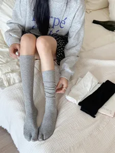 Detailed view of women's grey split toe slouch socks, soft cotton fabric for spring summer.