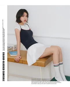 Silk blend color-blocked camisole top paired with t-shirt and skirt, lifestyle detail shot.