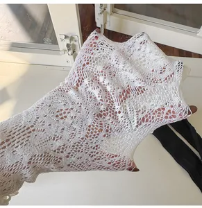 Close-up detail shot of white lace mesh tights showing stretchable fabric and floral pattern.