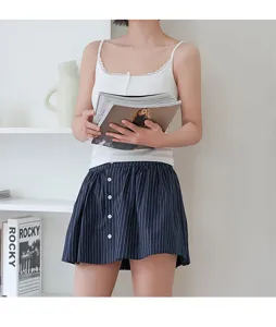 Detail view of women's ribbed lace camisole with chest pads and matching striped skirt.