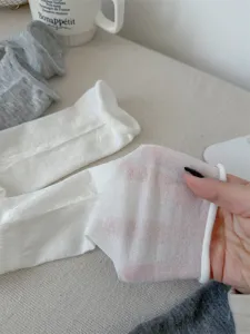 Sheer thin ballet style leg warmers detail shot, soft breathable fabric with rolled edge.