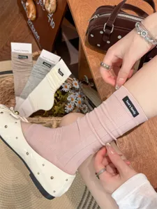 Ballet style women ribbed long calf socks with cute cloth label, comfortable daily wear.