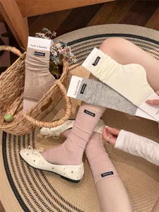 Detailed view of women's ballet style leg warmers and stack socks with ribbed texture, summer thin.