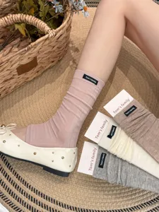 Ballet style stirrup socks for women, ribbed knit long stackable socks with cloth label.