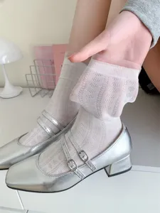Detail view of women's hollow lace cotton mid-tube slouchy socks showcasing texture and stretch.