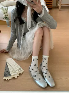 Calcetines blancos de mujer primavera verano con lazos negros y volantes muy bonitos.