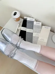Hollow out cotton mid-tube socks with lace ruffles, Japanese style stacked socks detail.
