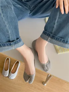 Detailed close-up of grey cotton split-toe invisible socks worn by model, cozy style.