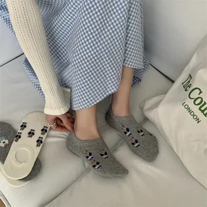 Close-up detail shot of cute bear pattern women cotton boat socks in lifestyle scene.