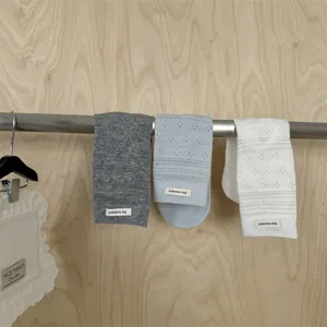 Close-up detail shot of Japanese style combed cotton hollow stacked socks in grey blue and white.