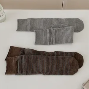 Detailed shot of women's thin striped cotton basic mid-tube slouch socks in gray and brown.