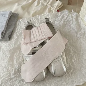 Detail view of women's cute ruffle mid-tube socks in solid pink, soft and stylish.