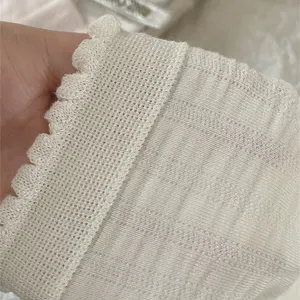 Close-up detail of women's solid color modal cotton ruffled socks, soft fabric texture.