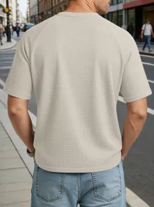 Back view of men's textured waffle knit short sleeve t-shirt with raglan design in beige.