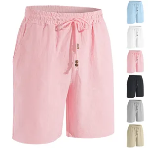Men's cotton linen beach shorts detail showing elastic drawstring waist and wooden beads.
