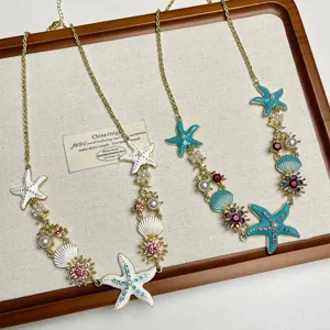 Detailed close-up view of beach style starfish and shell pendant details on the fashion necklace.