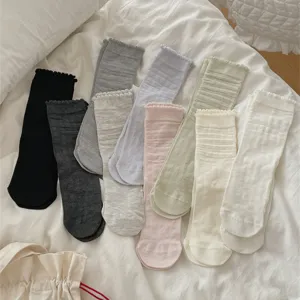 Detailed view of women's solid color ruffle mid-calf cotton slouch socks in various colors.