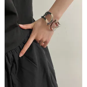 Chunky silver metallic open cuff bracelet for women, exaggerated fashion statement arm ring.