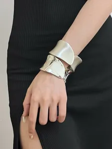 Exaggerated metal cuff bracelet, wide open design, smooth polished surface, elegant style.