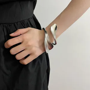 Silver leaf shape open metal bangle bracelet detail view, elegant minimalist jewelry accessory.