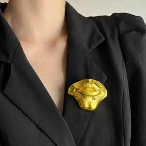 Abstract 3D golden lips brooch with rhinestone piercing detail, retro personality metal pin accessory.
