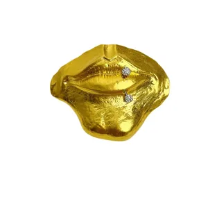 Gold lips brooch with crystal piercing studs, vintage metal texture stylish pin for daily wear now.